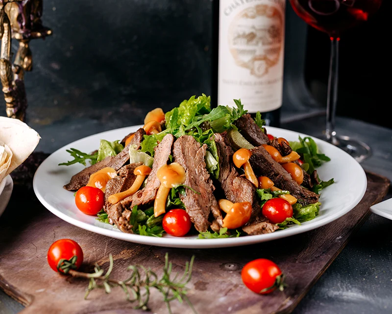 front-angle-meat-dish-yummy-sliced-meat-along-with-vegetables-brown-desk-dark-floor