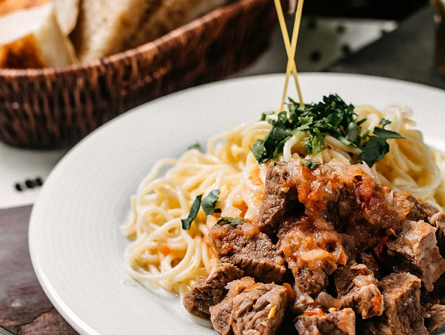 side-view-spaghetti-with-pieces-meat-tomato-wooden-board